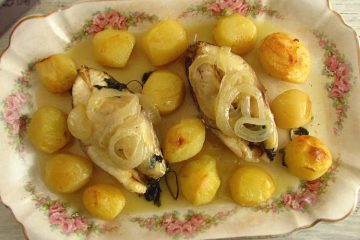 Snapper with potatoes in the oven on a platter