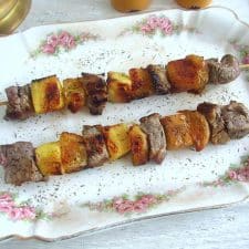 Veal kebabs with pineapple and orange on a platter