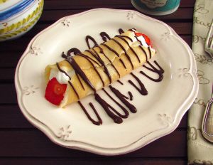 Crepe with strawberries on a plate