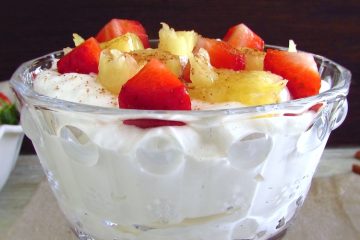 Chantilly with strawberries and pineapple on a glass bowl