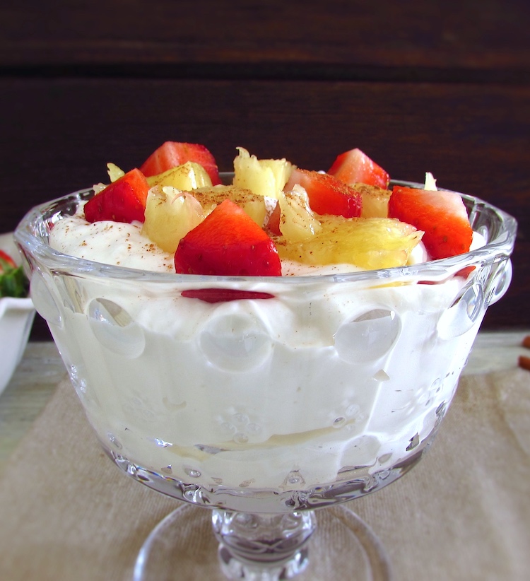 Chantilly with strawberries and pineapple on a glass bowl