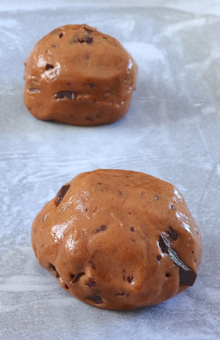 Chocolate cookies dough on a tray lined with parchment paper