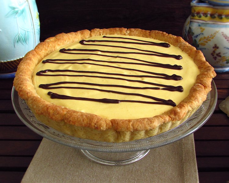 Mango pie garnished with chocolate on a plate