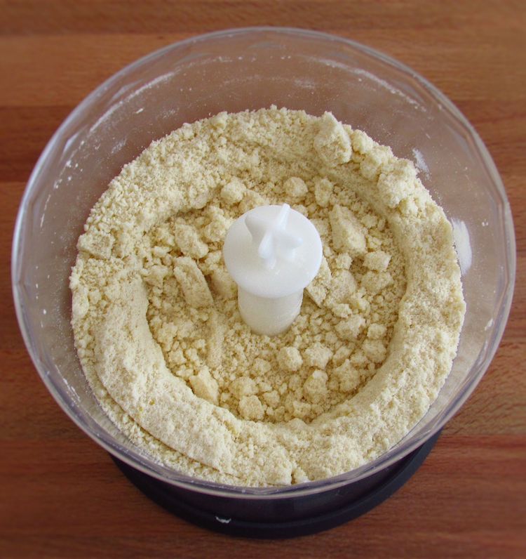 Flour, sugar, the margarine cut into cubes and the lemon zest mixed in a food processor