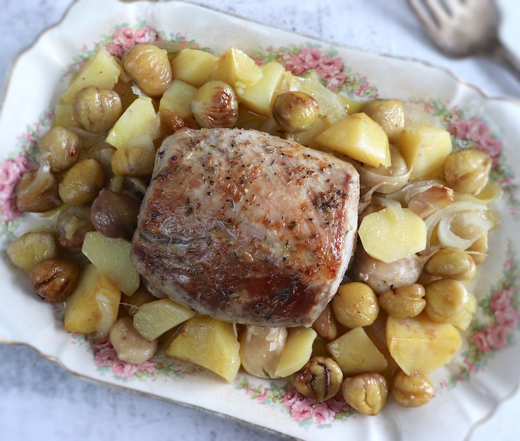 Baked pork loin with chestnuts on a platter