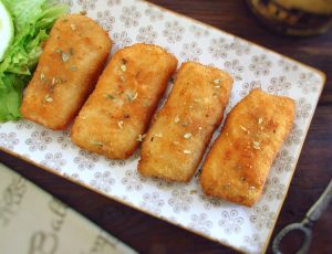 Breaded fish loins on a platter