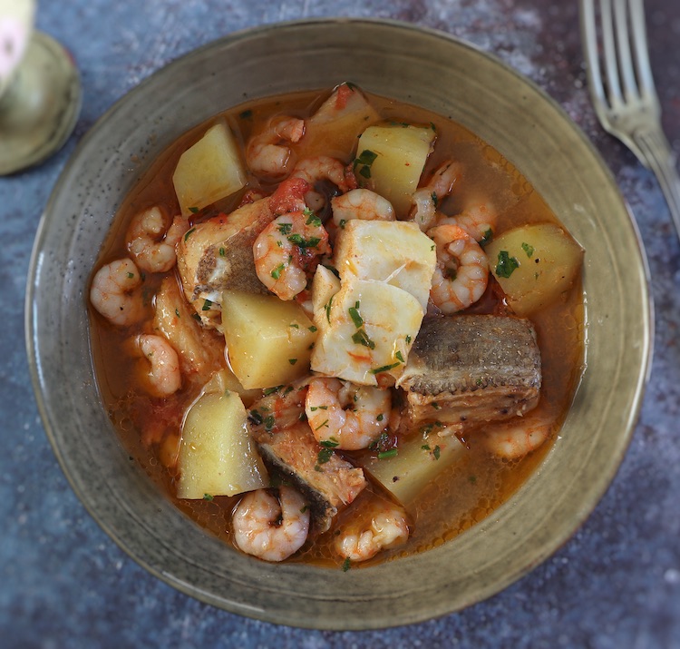 Cod stew with shrimp on a dish bowl