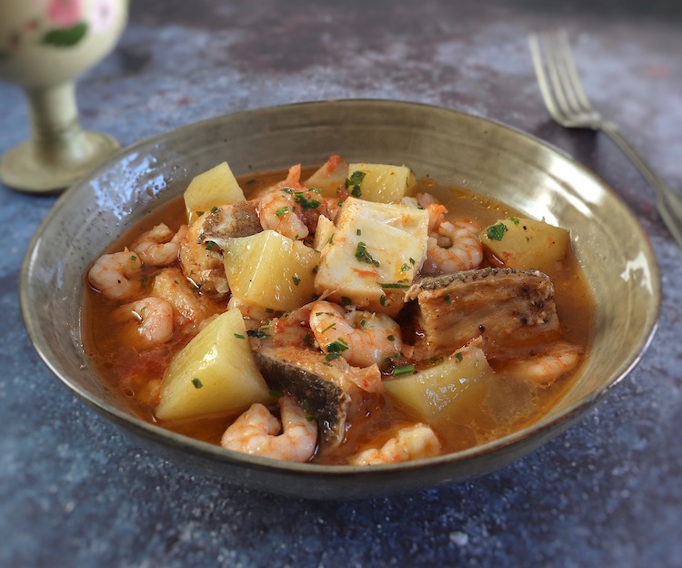 Cod stew with shrimp on a dish bowl