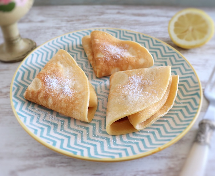 Crepes with lemon and sugar on a plate