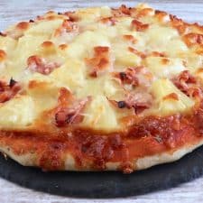 Ham and pineapple pizza on a table