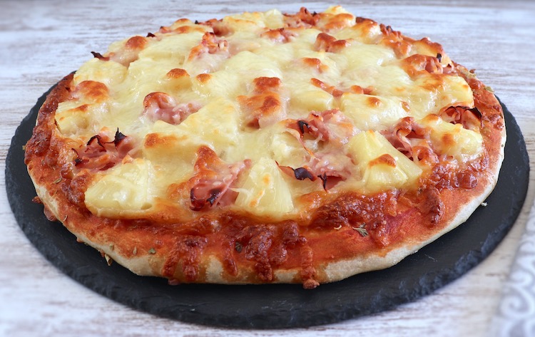 Ham and pineapple pizza on a table