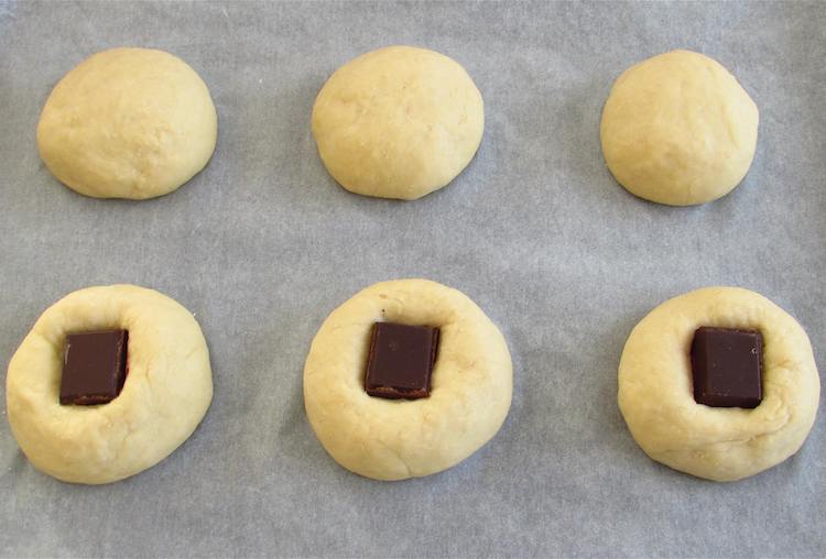 Milk bread dough divided in six with chocolate squares