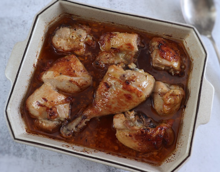 Roasted chicken with honey sauce on a baking dish