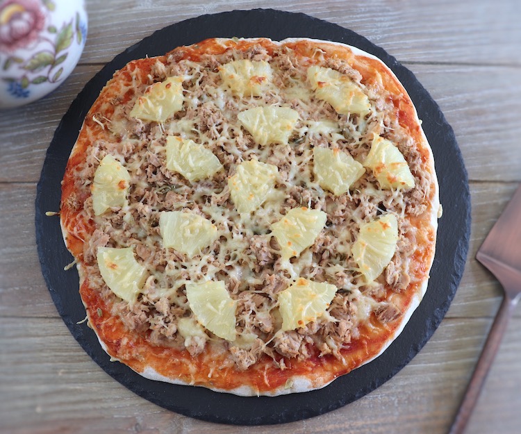 Tuna and pineapple pizza on a table