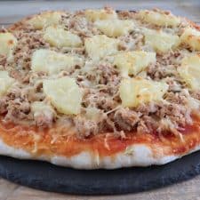Tuna and pineapple pizza on a table