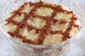 Creamy rice pudding with condensed milk on a glass bowl