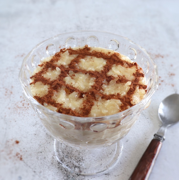 Creamy rice pudding with condensed milk on a glass bowl