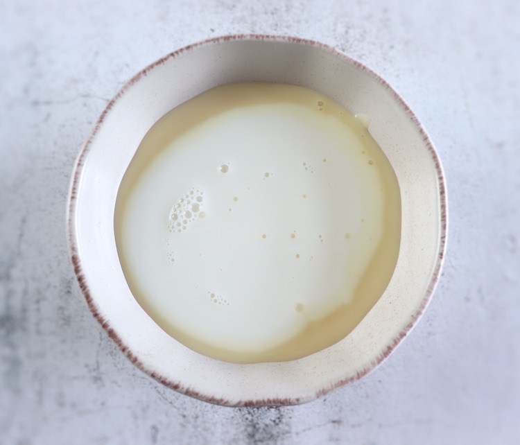 Sweetened condensed milk and milk on a bowl