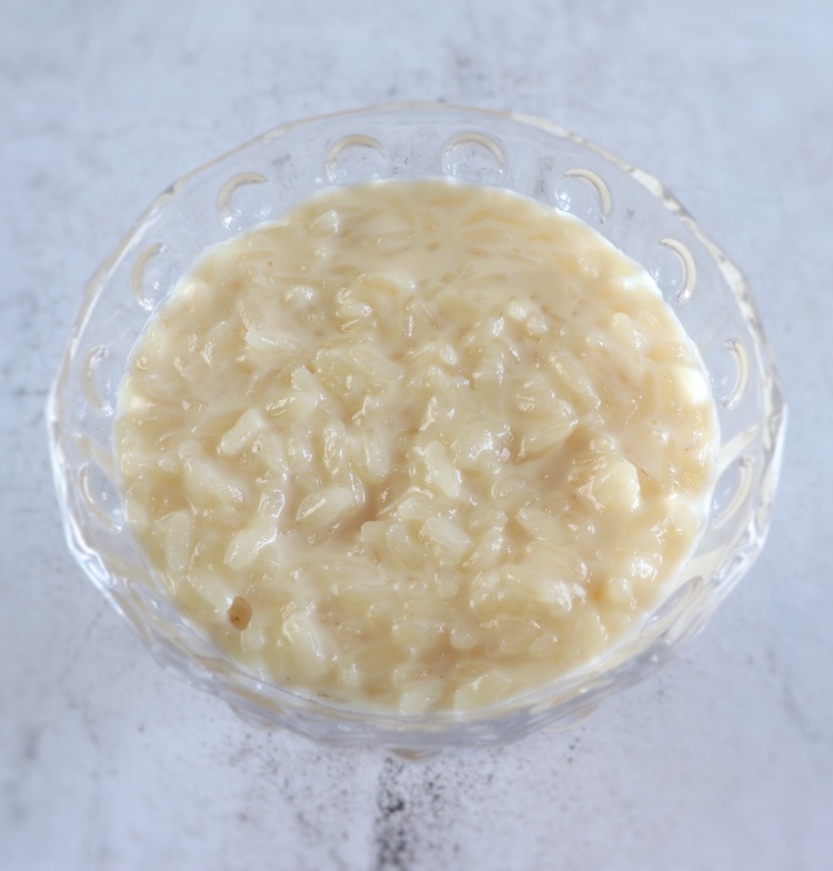 Rice pudding with sweetened condensed on a glass bowl
