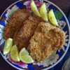 Breaded pork steaks in the oven on a plate