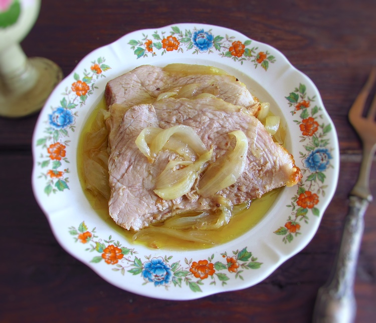 Slices of pork leg with mustard on a dish