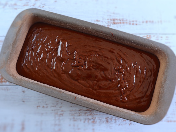 Soft chocolate cake dough on a loaf tin