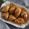 Easy baked chicken with orange and spices on a serving plate