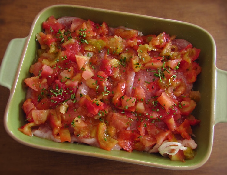 Turkey steaks with tomato on a baking dish