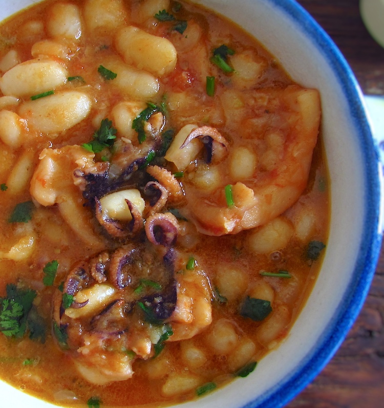 Stewed cuttlefish with white beans on a small tureen