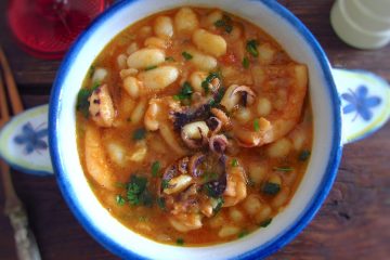 Stewed cuttlefish with white beans on a small tureen