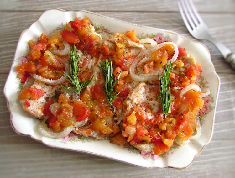Turkey steaks in the oven with tomato on a platter