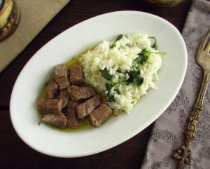 Veal cubes with coriander rice on a platter
