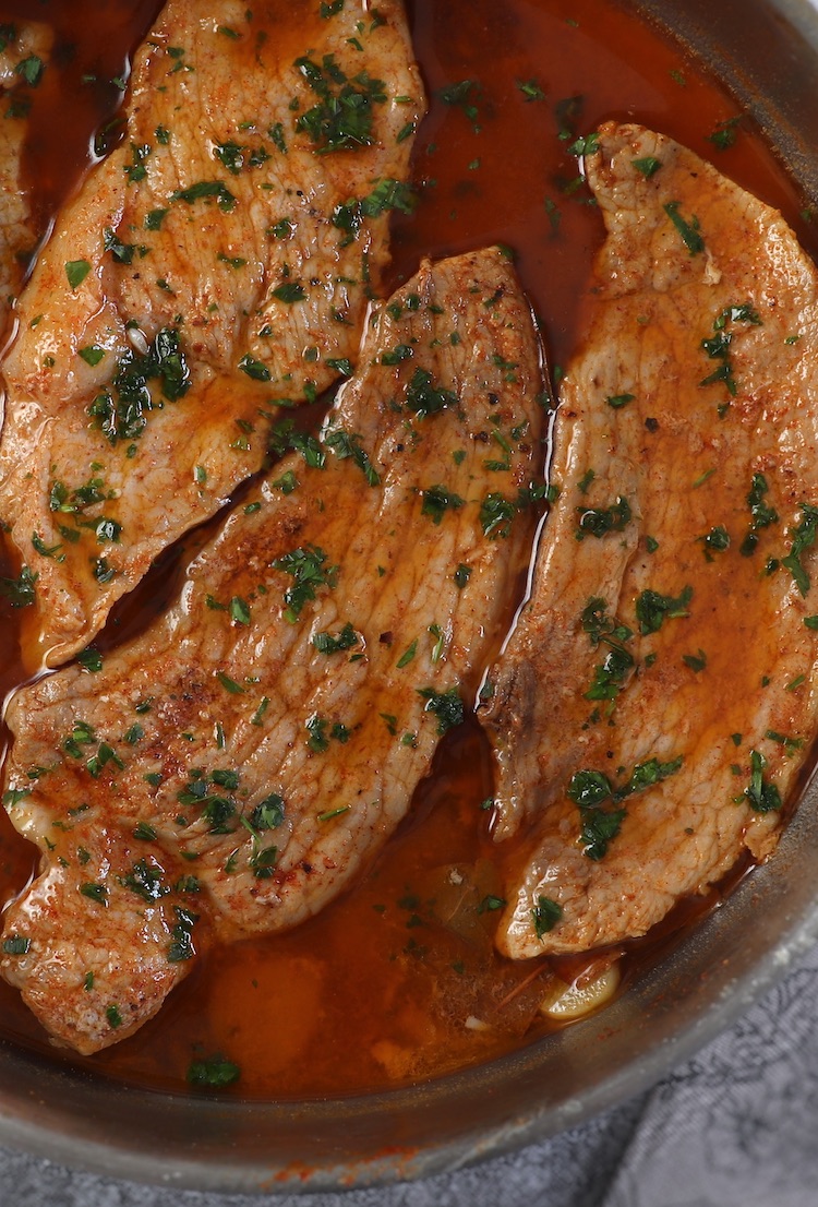 Easy pork steaks with delicious sauce on a frying pan