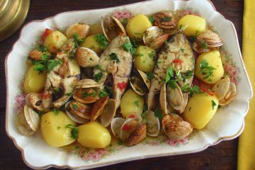 Wreckfish in the oven with clams on a platter