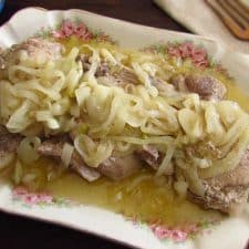 Pork chops with onion on a platter