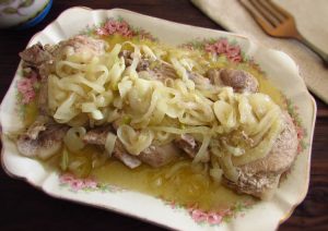 Pork chops with onion on a platter