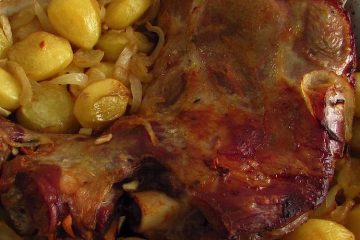 Leg of lamb in the oven on a baking dish