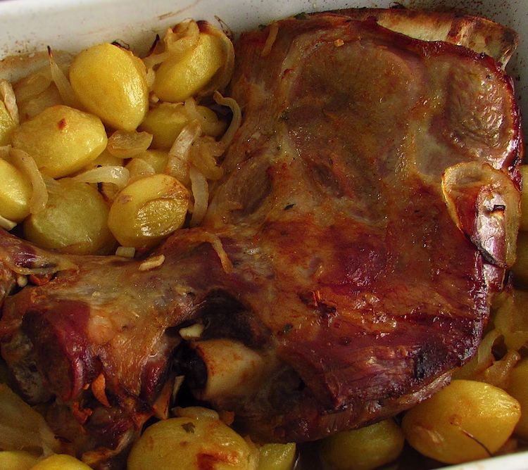 Leg of lamb in the oven on a baking dish