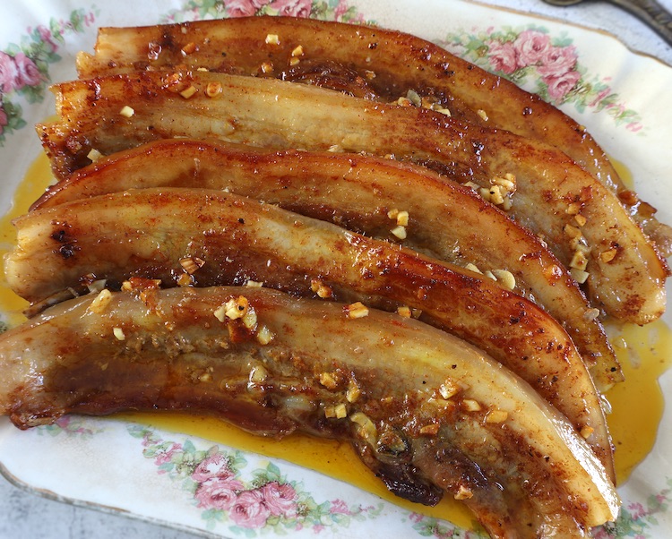 Roasted pork belly strips on a rectangular platter