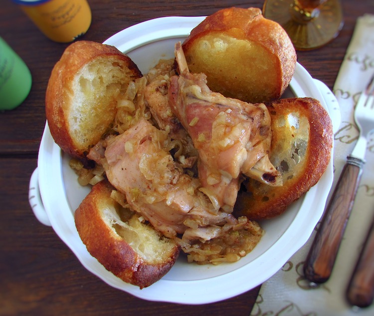Stewed rabbit with fried bread on a tureen