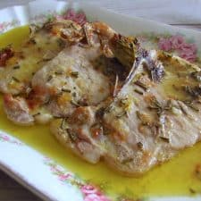 Baked pork chops with rosemary on a platter