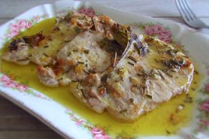Baked pork chops with rosemary on a platter