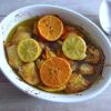 Baked chicken with orange and lemon on a baking dish