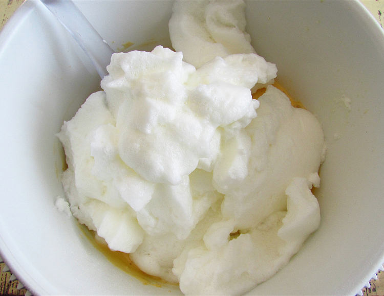 Apple cake dough in a bowl with whipped egg whites