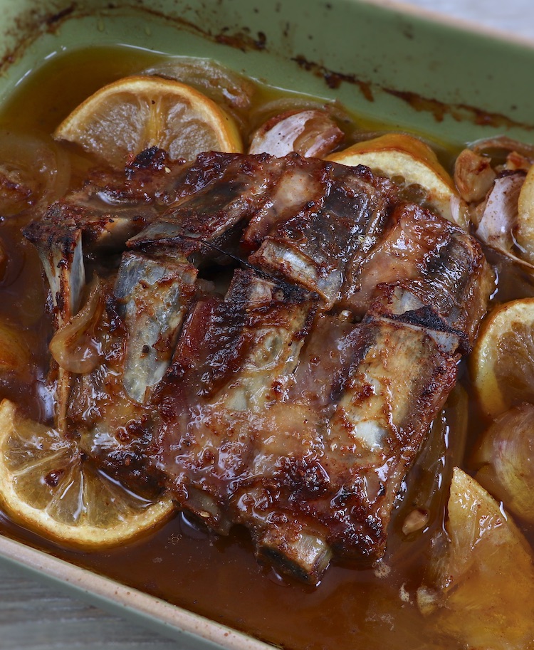 Baked pork ribs with lemon on a baking dish