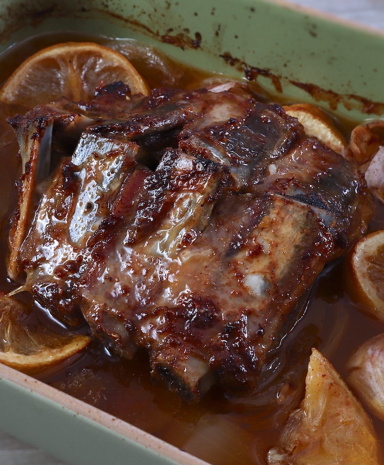 Baked pork ribs with lemon on a baking dish