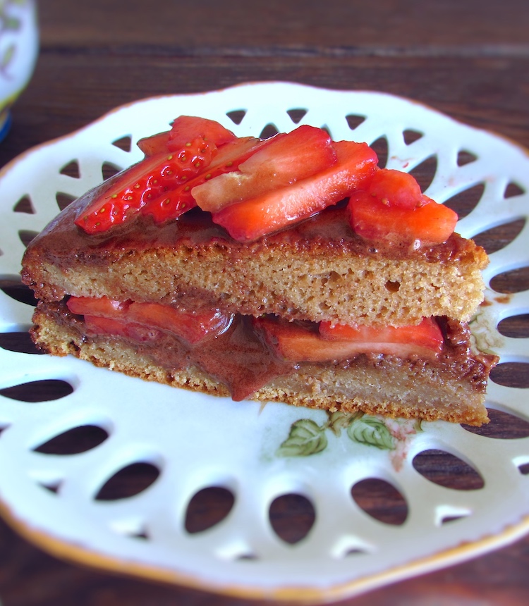 Slice of coffee cake with chocolate mousse and strawberries on a plate