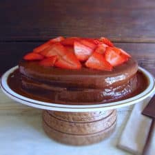 Coffee cake with chocolate mousse and strawberries on a plate