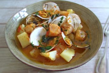 Monkfish stew with clams on a dish bowl