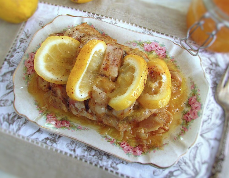 Stewed pork loin with lemon and honey on a platter